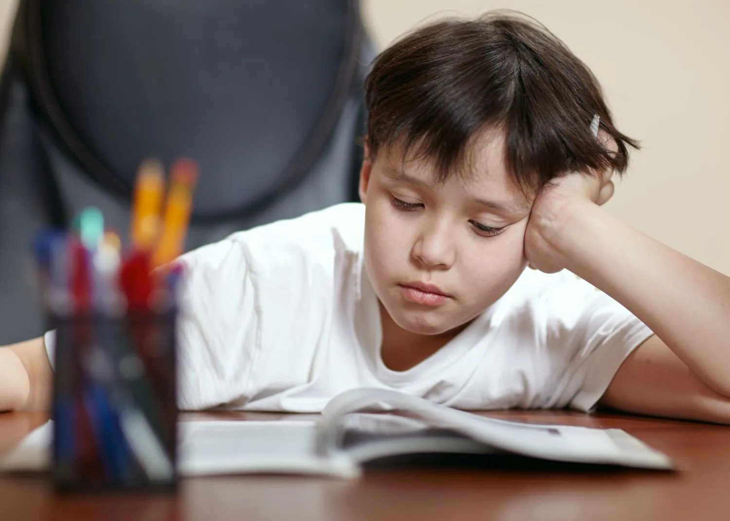 A boy working on a book at home